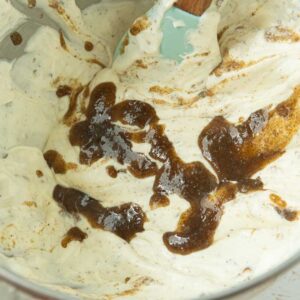 adding buttered rum syrup to ice cream base