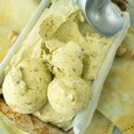 pistachio ice cream scoops in pan with ice cream scoop