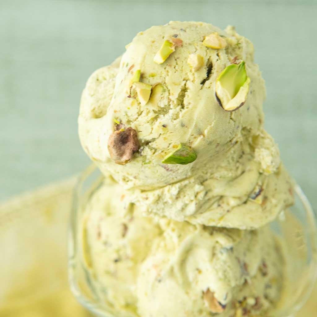 closeup of pistachio ice cream in glass dish