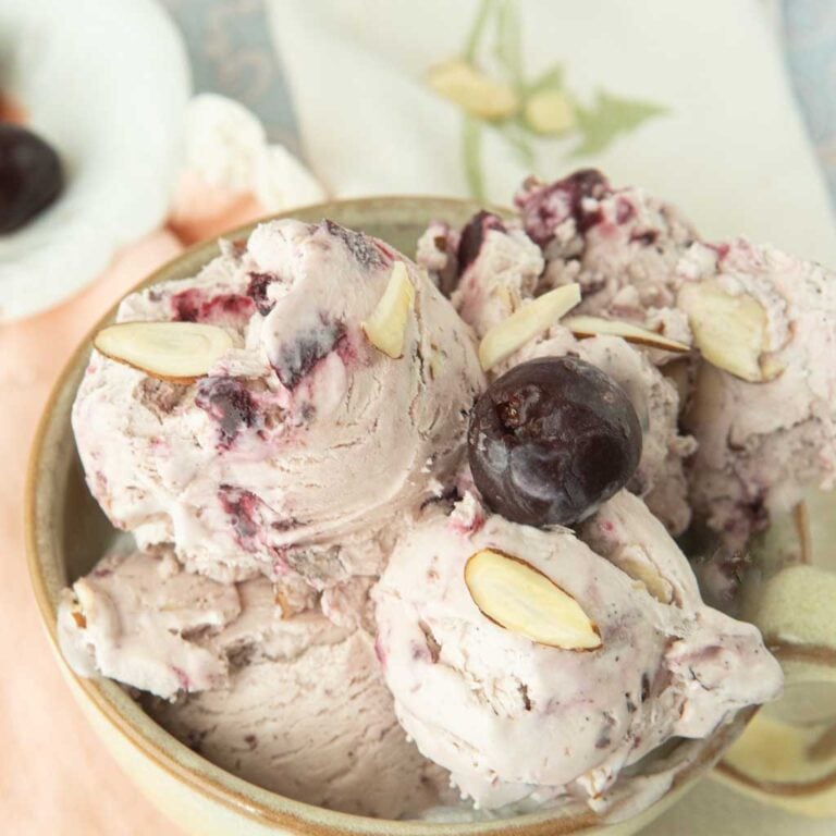 closeup of cheery ice cream in bowl with cherry on top