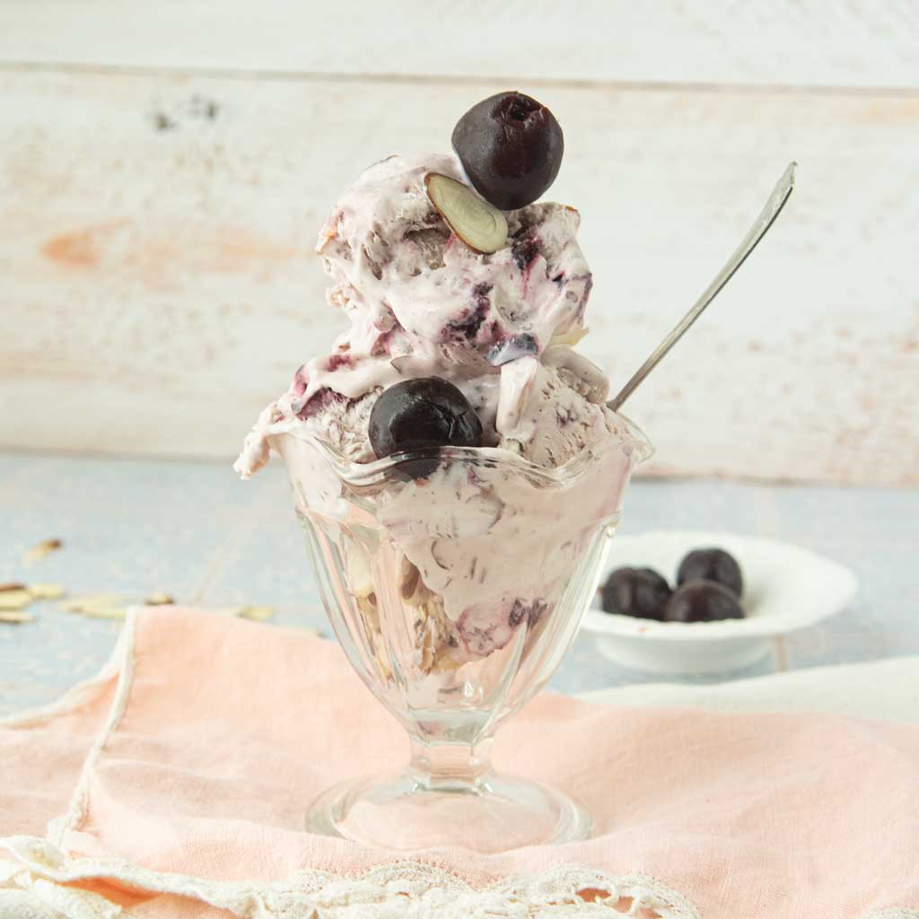 glass dish of cherry ice cream and whole cherries