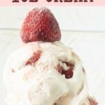 closeup of strawberry cheesecake ice cream topped with a whole strawberry, text overlay