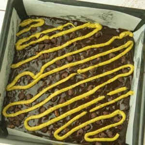 pistachio batter squeezed into lines on top of brownie batter