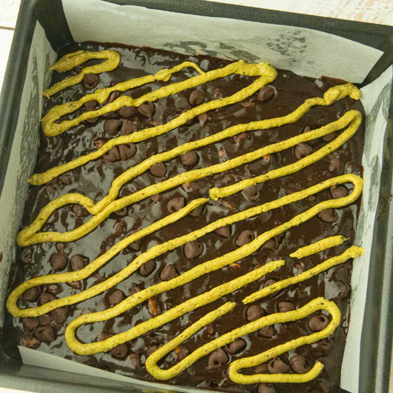pistachio batter squeezed into lines on top of brownie batter