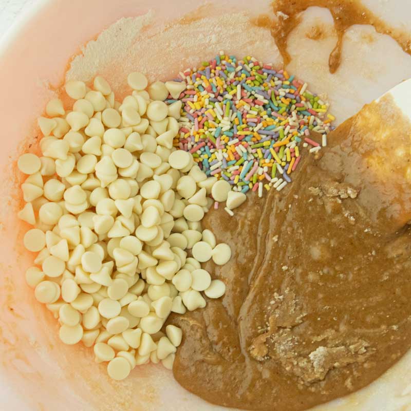 mixing white chocolate and sprinkles into brown butter blondies