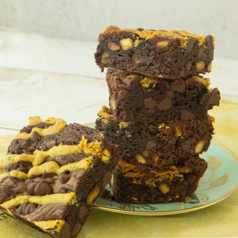 stack of pistachio brownies, side view on plate