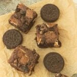 closeup of pieces of oreo brownies, whole chocolate sandwich cookies