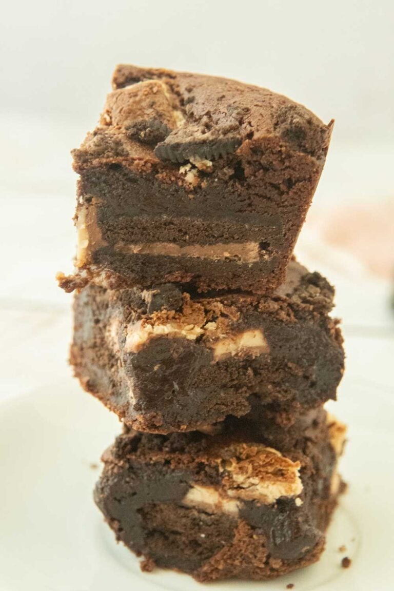 stack of oreo brownies, showing cross-section of whole cookie baked into the brownies