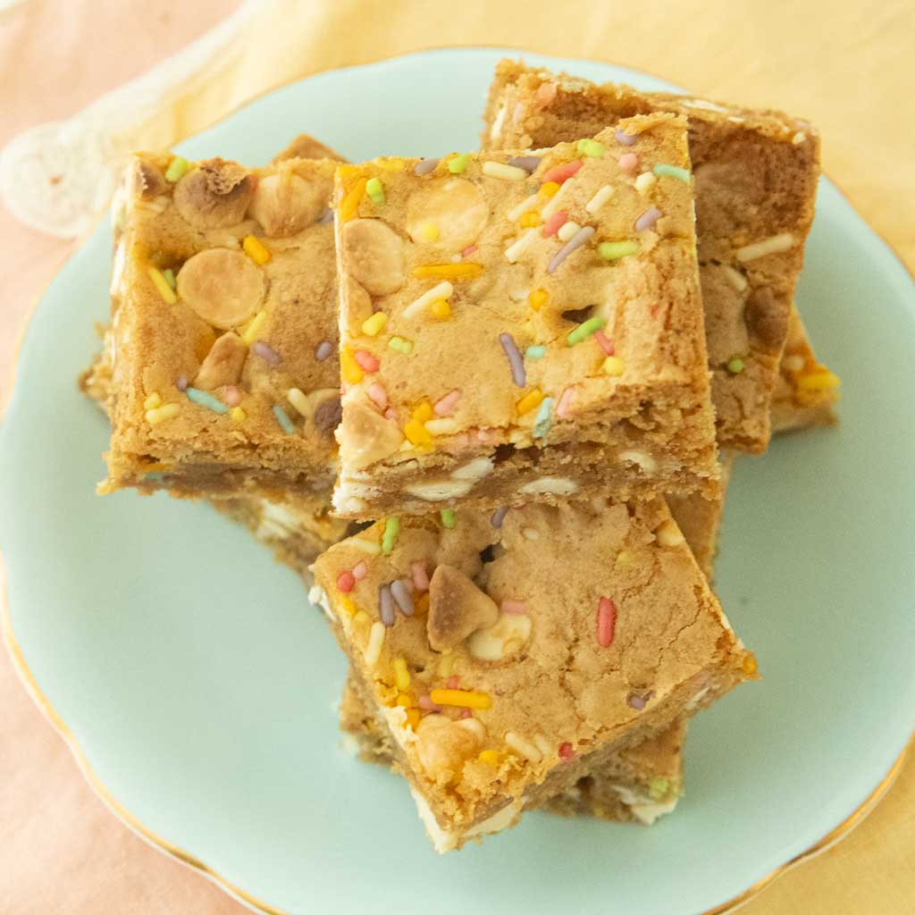 cut birthday cake blondies on plate