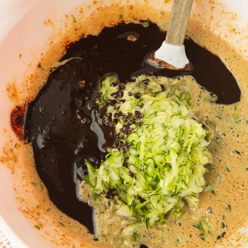 mixing melted chocolate and grated zucchini into batter for chocolate zucchini bread