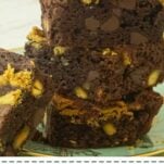 stack of pistachio brownies, side view on plate, text overlay