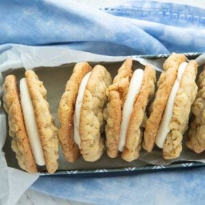 oatmeal cream pies in tin lined with parchment on blue napkin