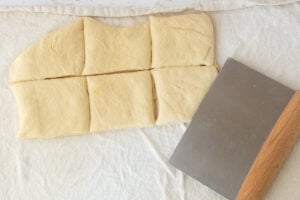 bench scraper, dough for homemade texas roadhouse rolls cut into squares
