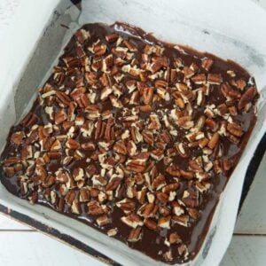 chopped pecans over brownie batter in pan