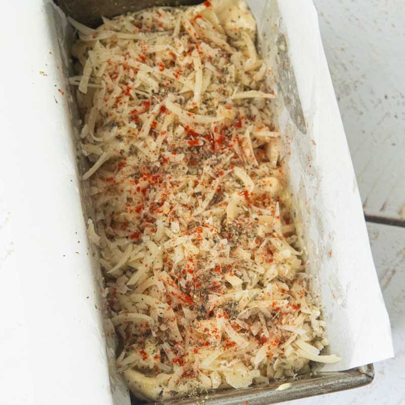 paprika and italian seasoning on top of garlic bread dough