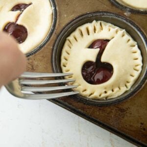 sealing edges of muffin pan pies with 