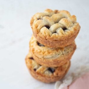 stack of mini cherry pies with lattice tops