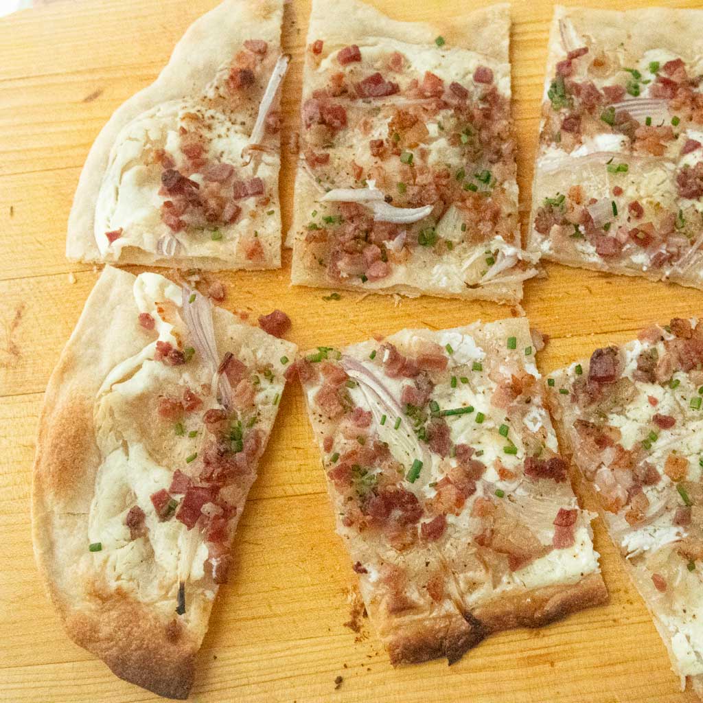 slices of flammkuchen on board