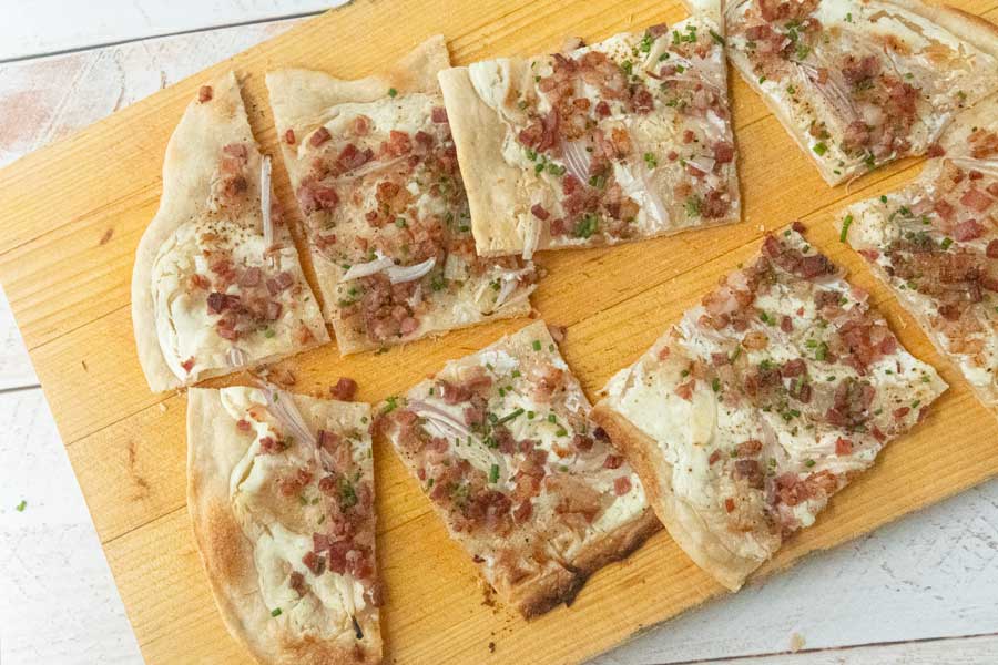 slices of flammkuchen on board