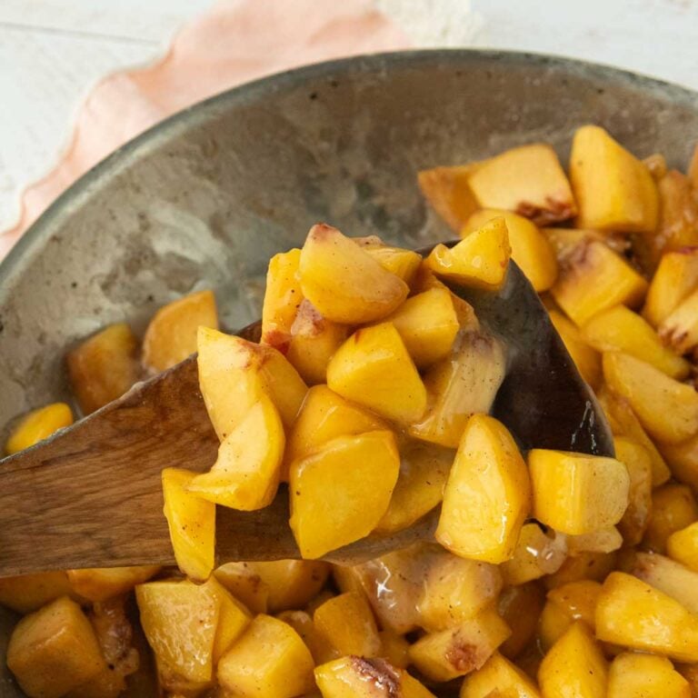 peach pie filling on wood spatula in pan
