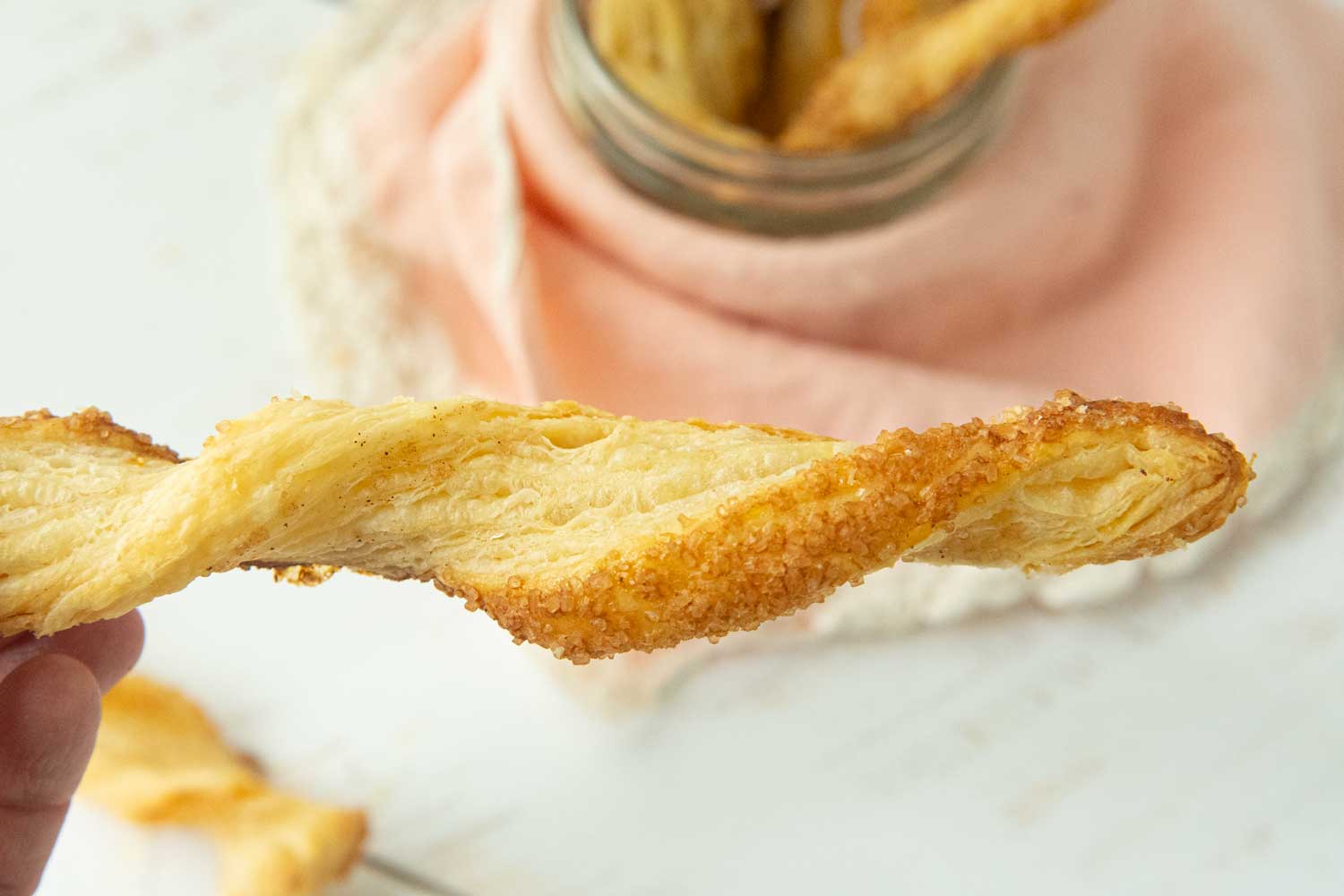 closeup of the coarse sugar on a puff pastry cinnamon twist