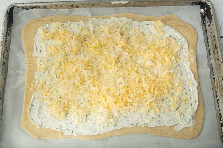 grated butterkase cheese on puff pastry