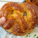 closeup of hand holding soft pretzel