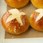 closeup of pretzel buns, baked on baking sheet