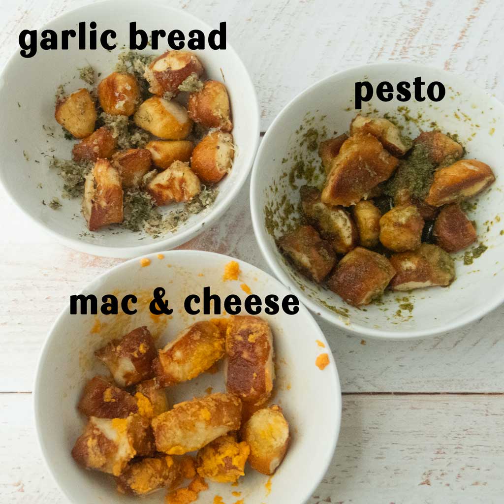 garlic bread, pesto, and mac & cheese flavored pretzel bites in bowls