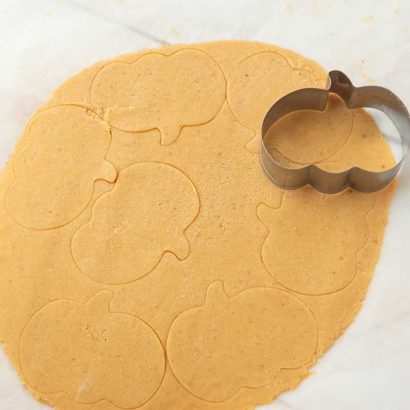 pumpkin cookie cutter on pumpkin cutout dough