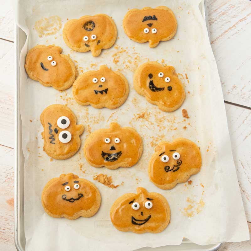 jack-o-lantern cookies on cookie sheet