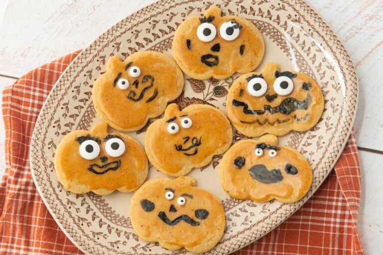 closeup of jack-o-lantern cookies on plate
